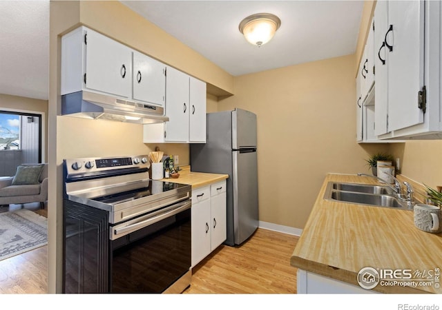 kitchen with sink, stainless steel appliances, and white cabinets