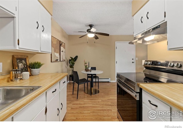 kitchen featuring stainless steel electric stove, white cabinetry, ceiling fan, a textured ceiling, and light hardwood / wood-style flooring