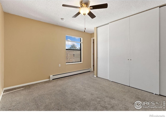 unfurnished bedroom with a textured ceiling, a baseboard radiator, light colored carpet, and ceiling fan