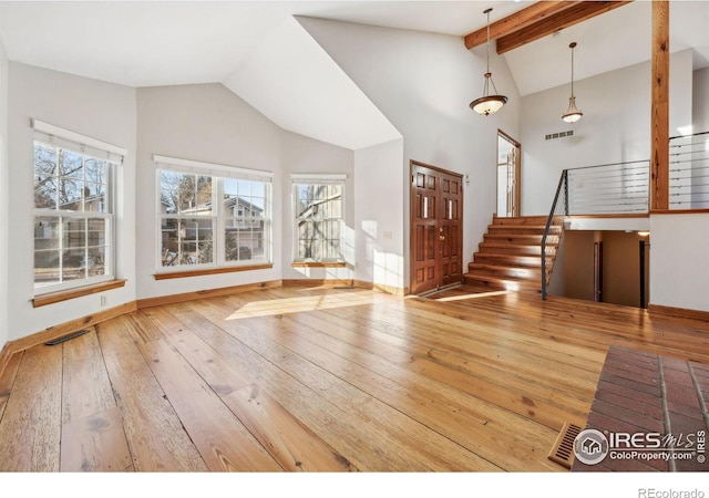 entryway featuring hardwood / wood-style flooring, high vaulted ceiling, and beamed ceiling