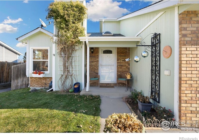 doorway to property with a yard