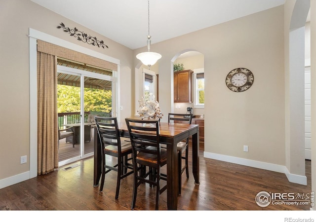 dining area with dark wood-type flooring