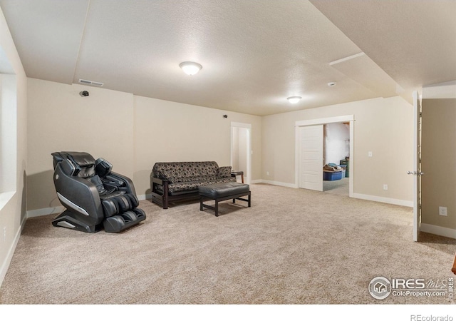 carpeted living room featuring a textured ceiling