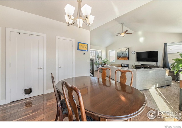 dining room featuring vaulted ceiling, ceiling fan with notable chandelier, and dark hardwood / wood-style flooring