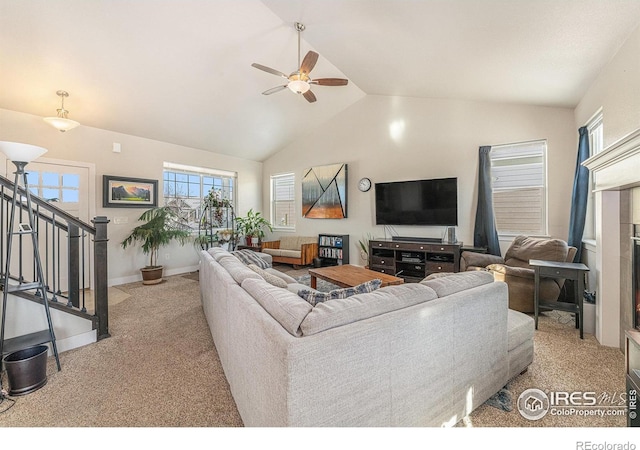 living room featuring ceiling fan, vaulted ceiling, and light carpet