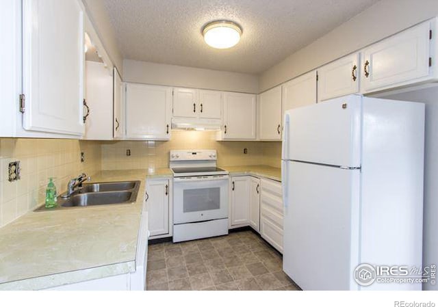 kitchen featuring sink, white cabinetry, a textured ceiling, white appliances, and backsplash