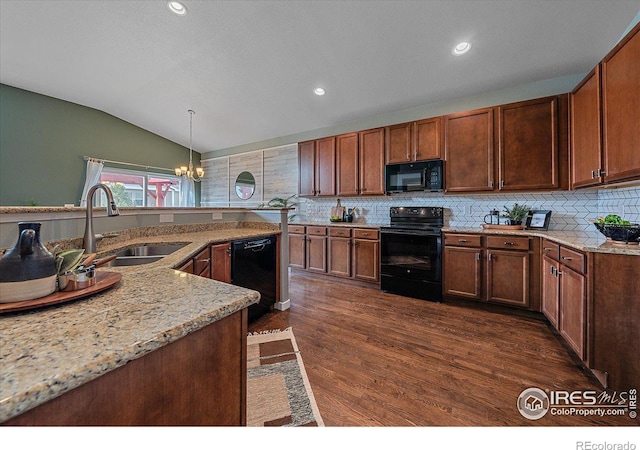 kitchen with lofted ceiling, sink, dark hardwood / wood-style flooring, hanging light fixtures, and black appliances