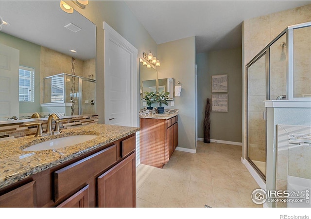 bathroom featuring vanity, an enclosed shower, and tile patterned flooring