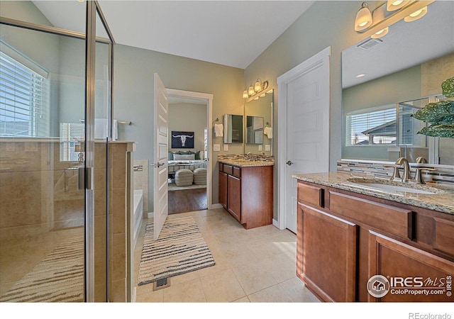 bathroom featuring vanity, a shower with door, and tile patterned floors