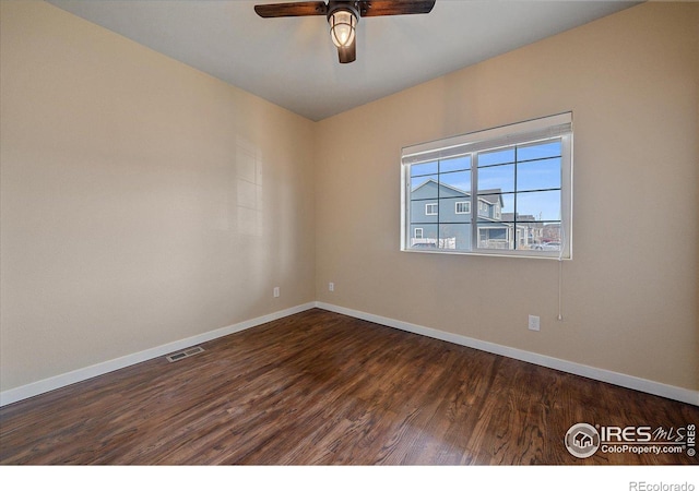 spare room featuring ceiling fan and dark hardwood / wood-style floors