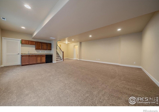 unfurnished living room featuring carpet