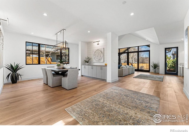 foyer entrance featuring lofted ceiling and light hardwood / wood-style floors