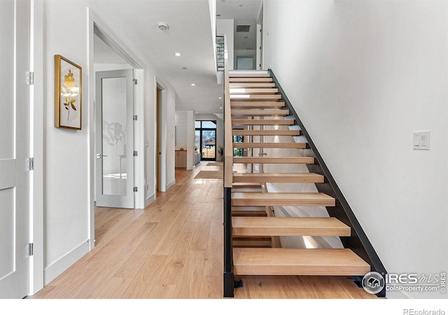 stairway featuring hardwood / wood-style floors