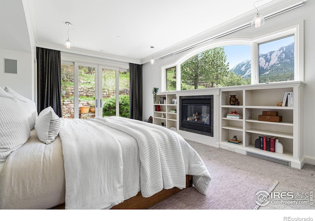 bedroom featuring crown molding and carpet