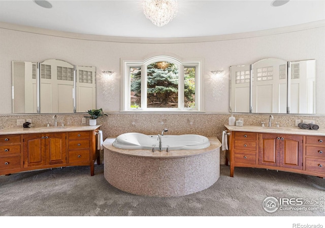 bathroom with ornamental molding, a tub, vanity, and decorative backsplash