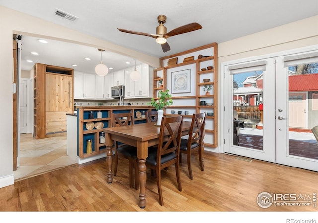 dining room featuring light hardwood / wood-style floors, french doors, and ceiling fan