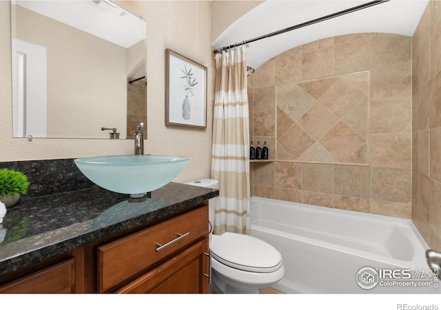 full bathroom with shower / bath combo, vanity, and toilet