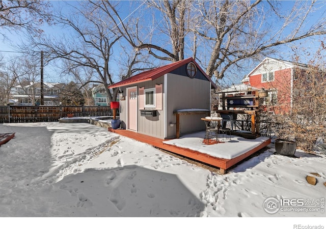 snowy yard with an outbuilding