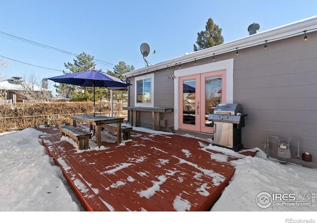 view of patio with area for grilling, a wooden deck, and french doors