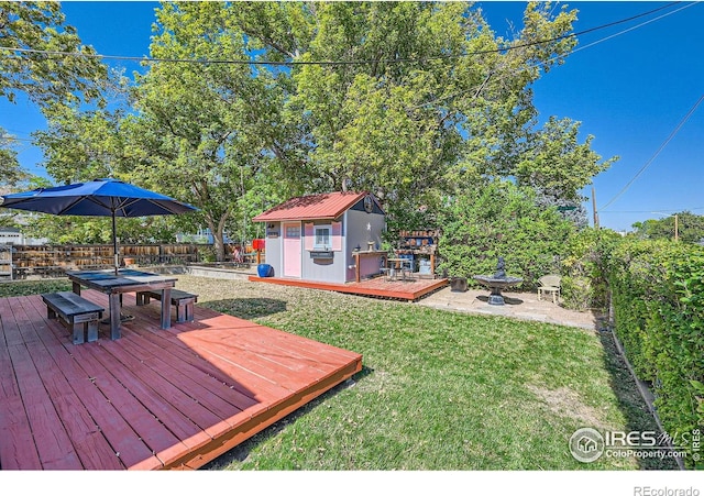 view of yard with a storage shed and a deck