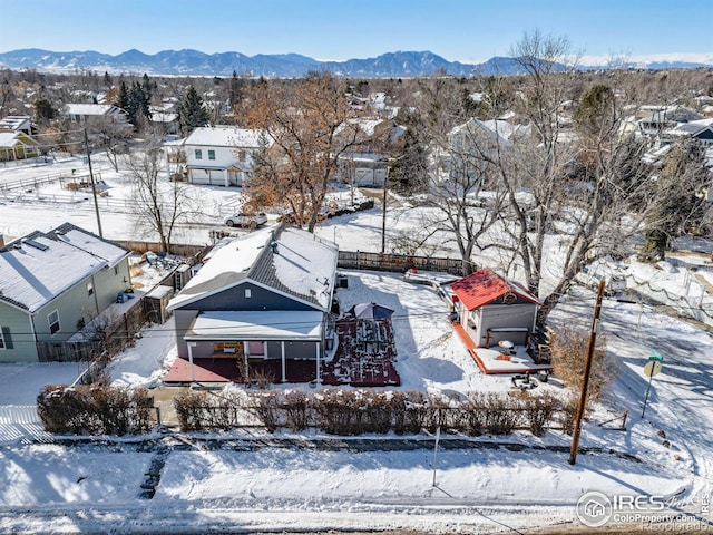 snowy aerial view featuring a mountain view