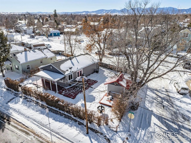 snowy aerial view with a mountain view