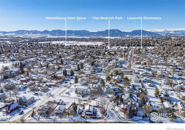 snowy aerial view featuring a mountain view