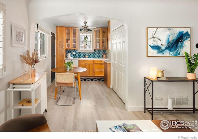 dining area with ceiling fan and light hardwood / wood-style floors