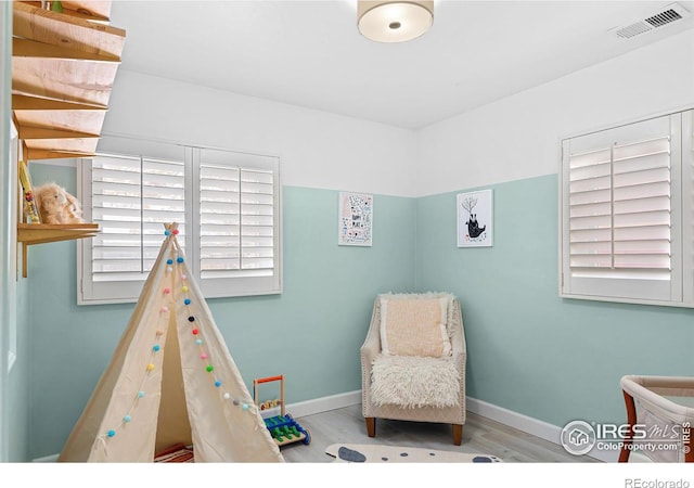 playroom with light hardwood / wood-style flooring