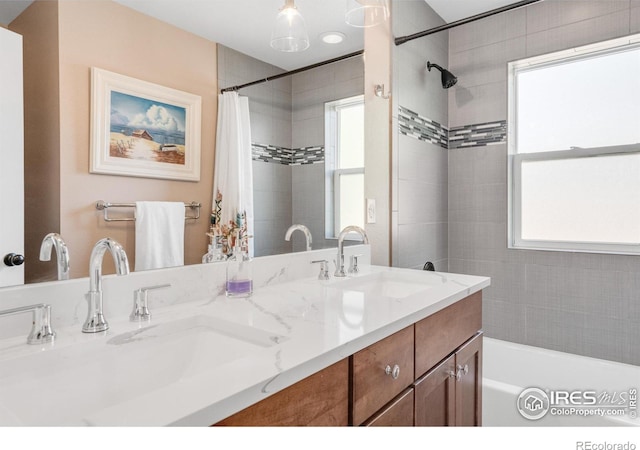 bathroom featuring vanity, a healthy amount of sunlight, and shower / tub combo with curtain