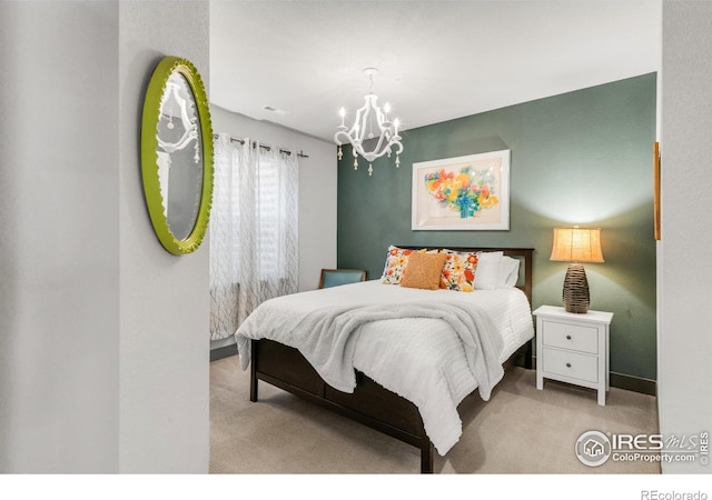 carpeted bedroom featuring an inviting chandelier