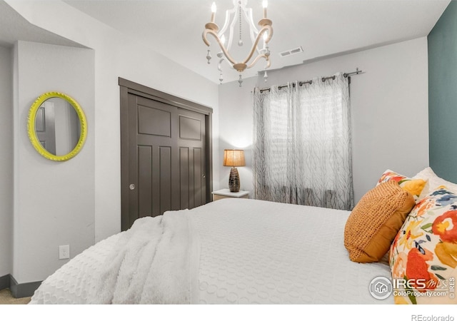 bedroom featuring a closet and a notable chandelier