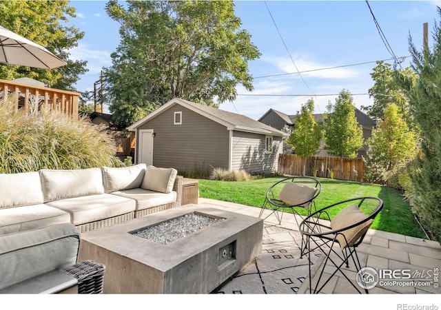 view of patio featuring an outdoor structure and an outdoor living space with a fire pit