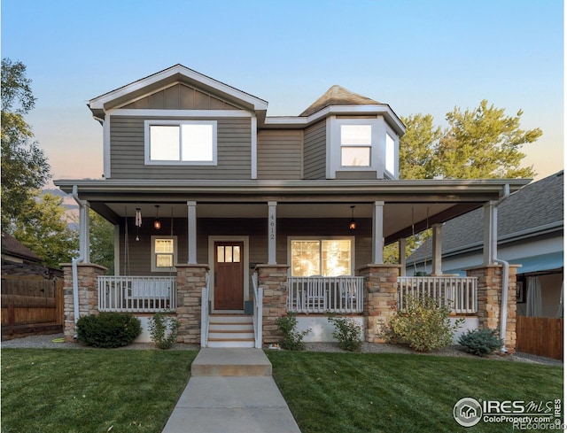 view of front of house with a porch and a yard