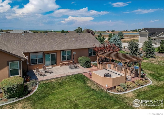 back of property featuring a yard, a pergola, and a patio