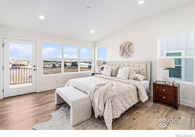 bedroom with light wood-type flooring, vaulted ceiling, and access to exterior