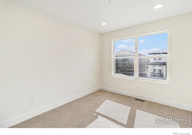 unfurnished room featuring carpet