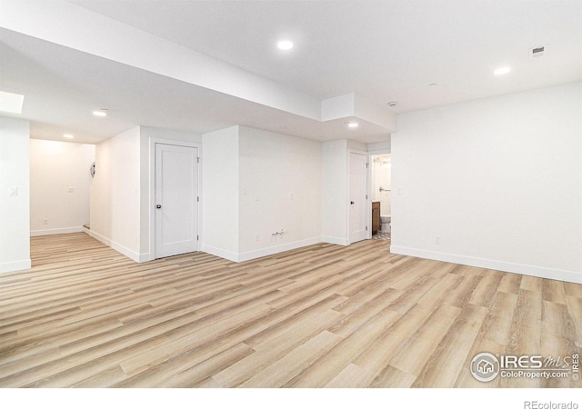 spare room featuring light hardwood / wood-style floors