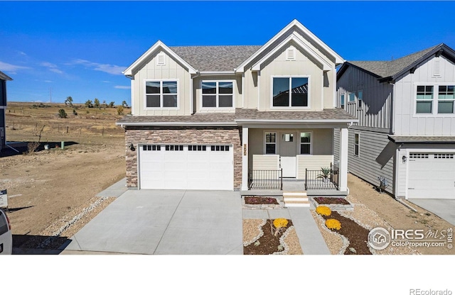 view of front facade featuring covered porch and a garage