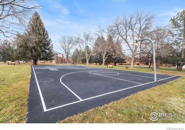 view of sport court with a lawn