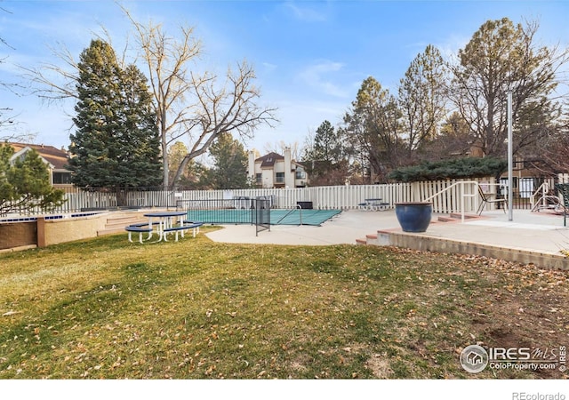 view of pool featuring a patio area and a lawn