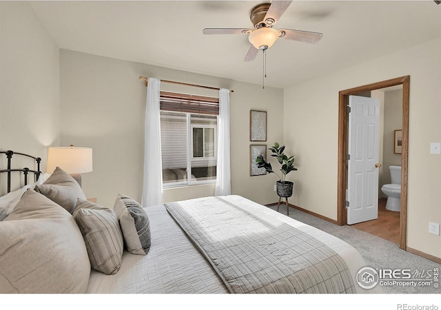 carpeted bedroom with ensuite bath and ceiling fan