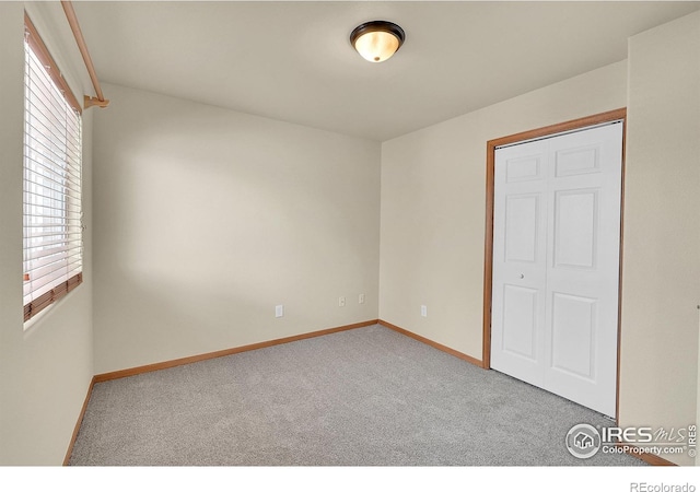 unfurnished bedroom featuring a closet and carpet flooring