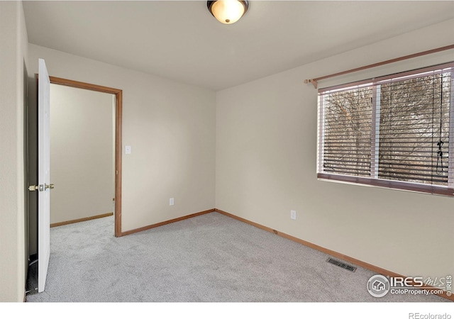 unfurnished room with light colored carpet