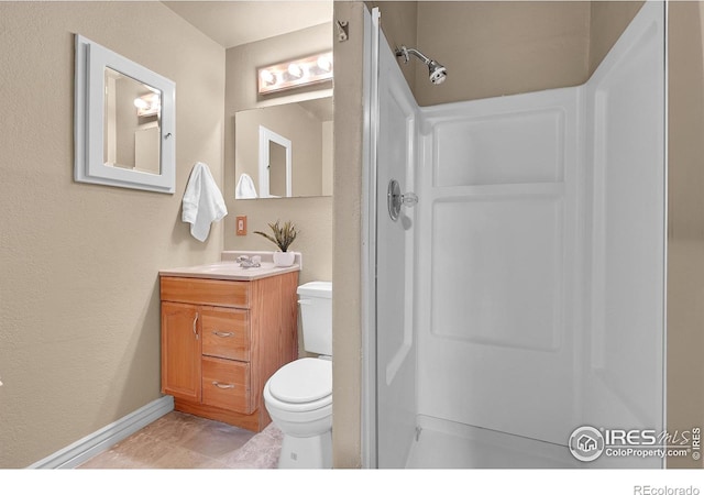 bathroom featuring vanity, tile patterned flooring, and toilet