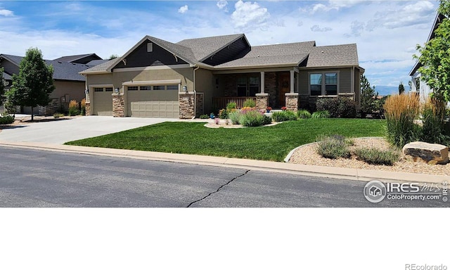 view of front of home with a garage, a front lawn, and a porch