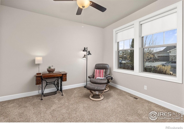 sitting room featuring ceiling fan and carpet