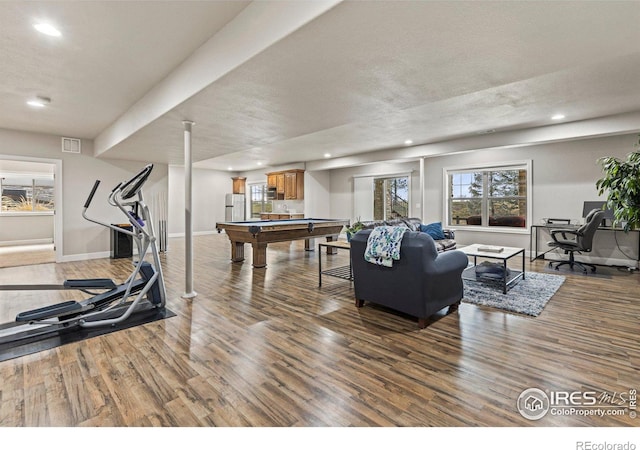 interior space with hardwood / wood-style flooring, a textured ceiling, and billiards