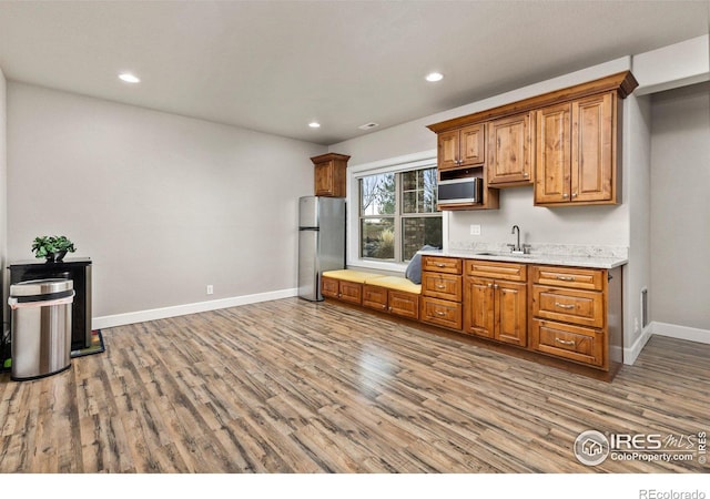 kitchen featuring stainless steel appliances, sink, and hardwood / wood-style floors