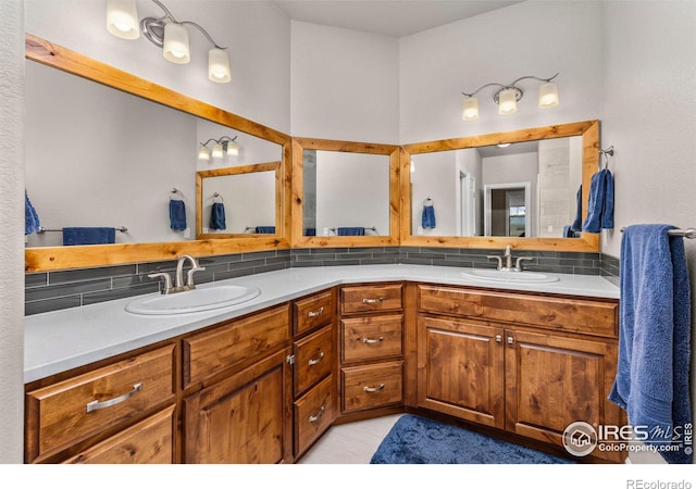 bathroom featuring tasteful backsplash, vanity, and tile patterned floors